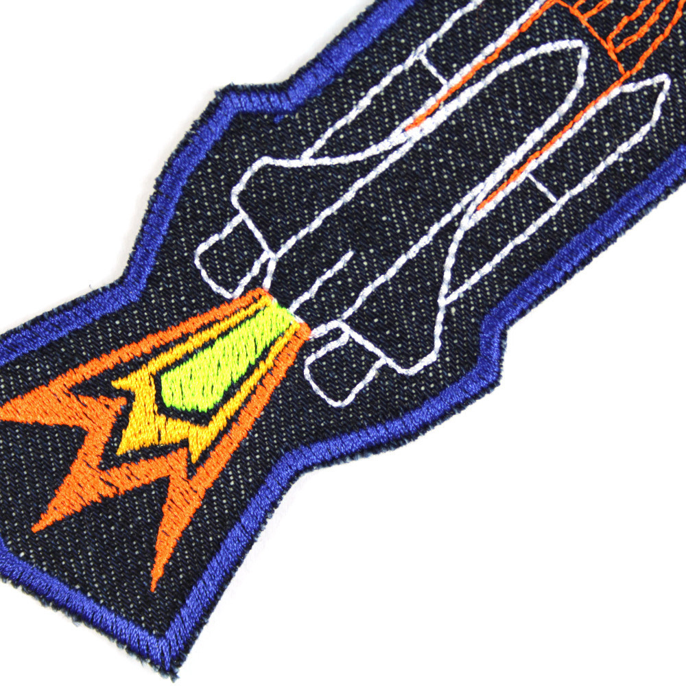 Detail des Raumschiff Patch mit Feuerstoß in neongelb und neonorange