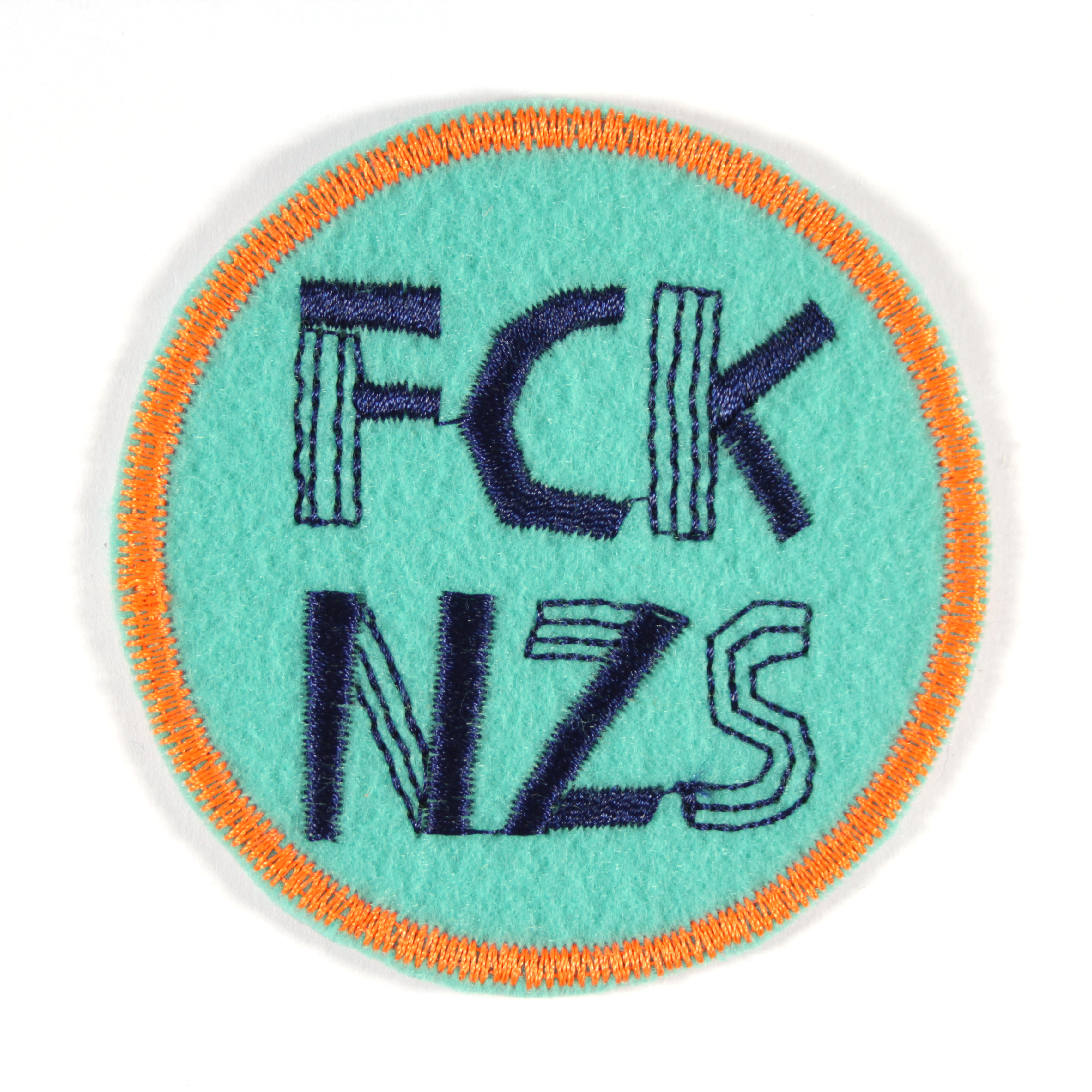 Aufnäher rund FCK NZS auf türkis mit neon orange rand